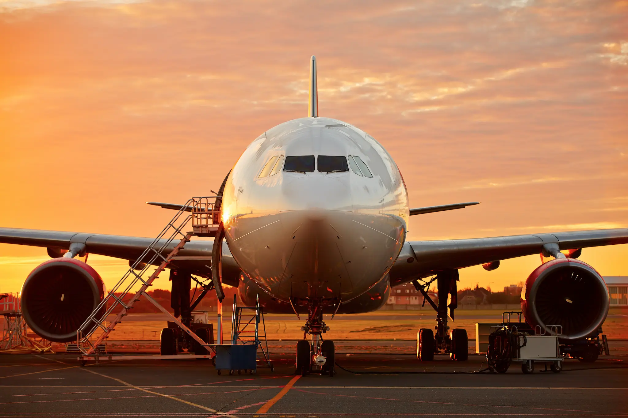 Avión estacionado al atardecer en una pista de aterrizaje, representando sanciones a compañías aéreas.